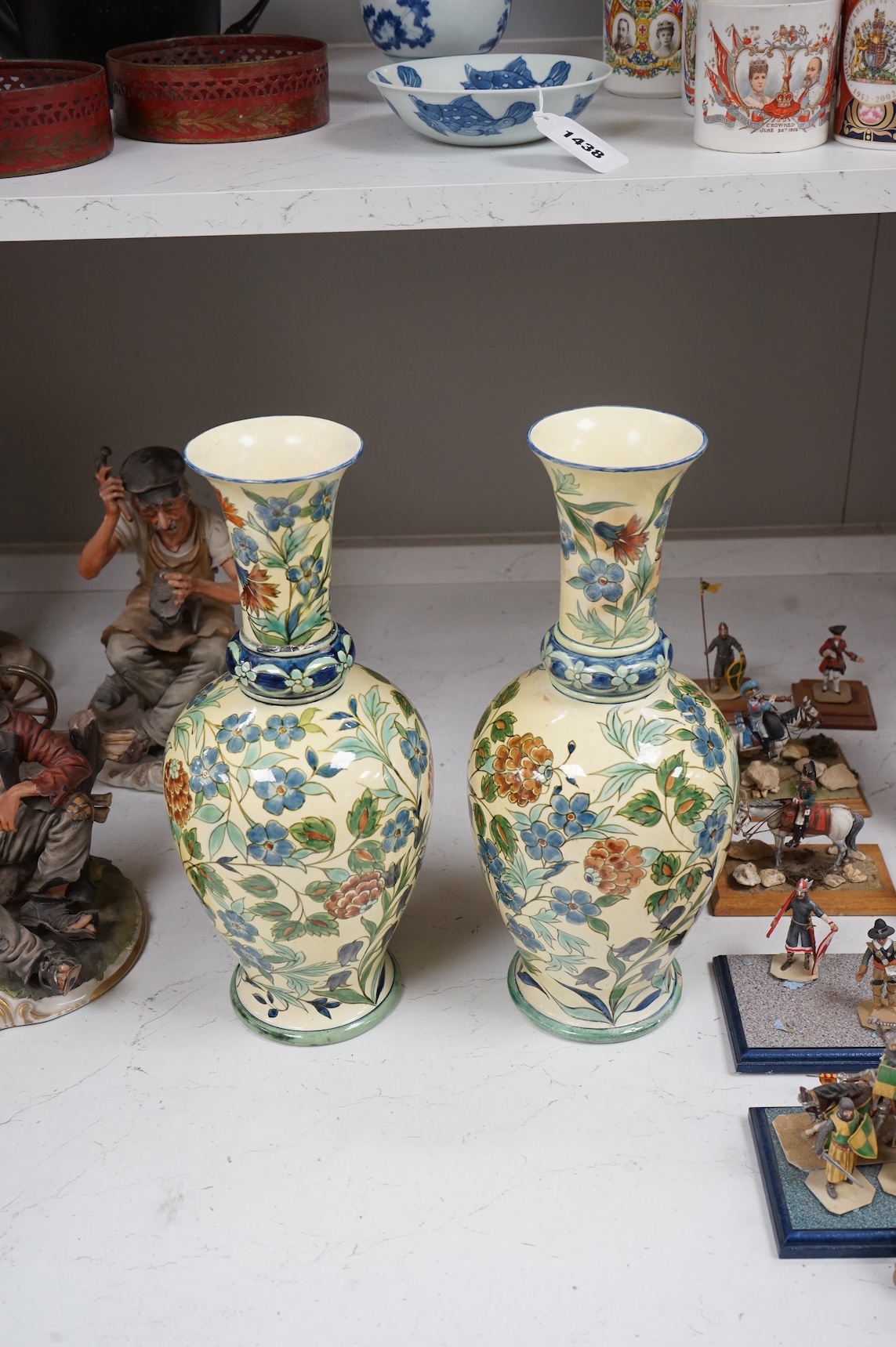 A pair of Doulton Lambeth Persian inspired faience vases, dated 1877, restored, 37cm high